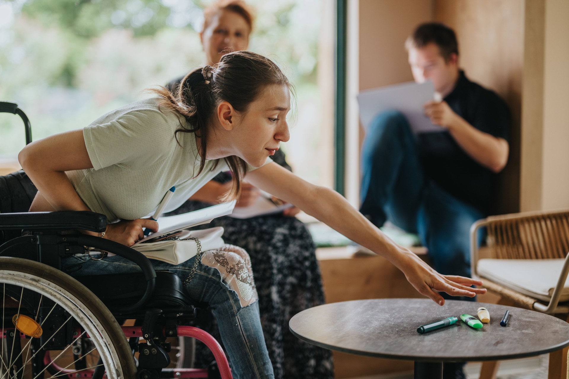 Young adults with disabilities enjoying a creative group activity at cozy home setting.